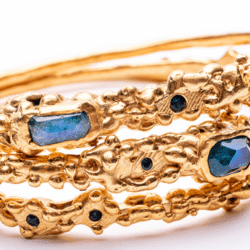 Gold Bangle with blue stones by Bea Jareno. An exhibitor at Craftworks.